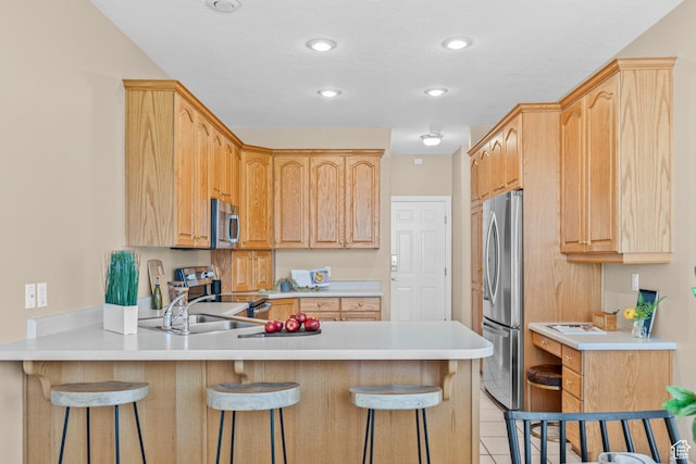 11815 S Cottage Side Way E, Draper, UT 84020 - kitchen featuring appliances with stainless steel finishes, a peninsula, a breakfast bar, light countertops, and recessed lighting