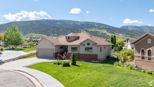 935 S 950 E, Ephraim, UT 84627 - view of front of property with a mountain view, a front lawn, concrete driveway, a garage, and stucco siding