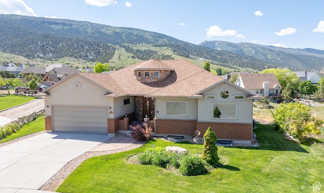 935 S 950 E, Ephraim, UT 84627 - view of front of home with an attached garage, brick siding, a mountain view, driveway, and a front lawn