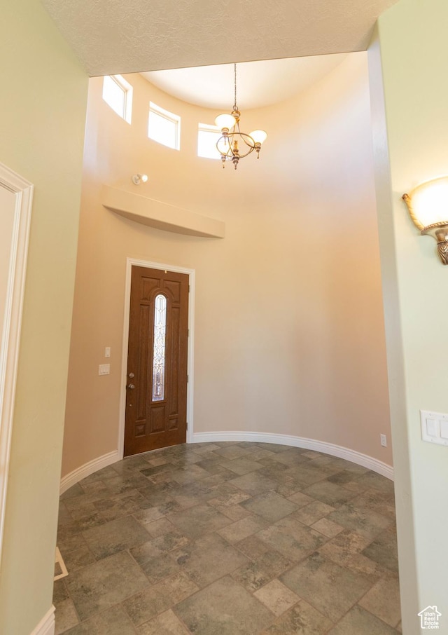 935 S 950 E, Ephraim, UT 84627 - entryway featuring stone finish flooring, baseboards, a towering ceiling, and a chandelier