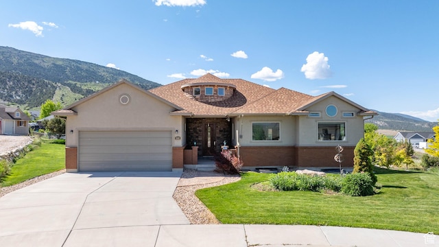 935 S 950 E, Ephraim, UT 84627 - view of front of home featuring a garage, a mountain view, driveway, and a front yard