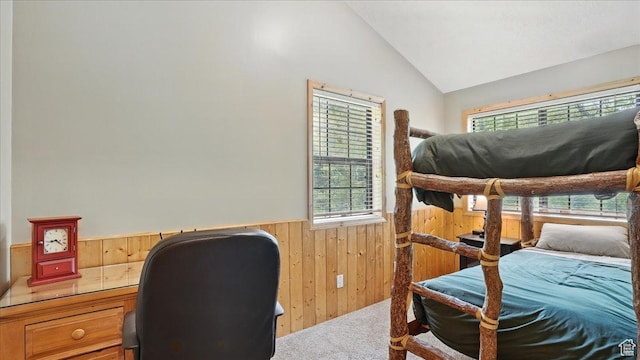 3786 Beaver Creek Rd, Kamas, UT 84036 - carpeted bedroom featuring multiple windows, wood walls, a wainscoted wall, vaulted ceiling, and a desk