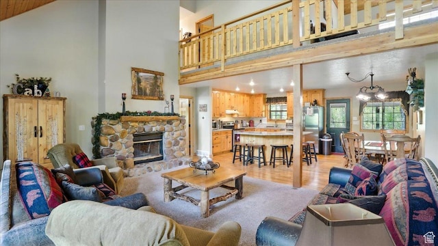 3786 Beaver Creek Rd, Kamas, UT 84036 - living area featuring a towering ceiling, light wood-type flooring, a fireplace, a chandelier, and recessed lighting