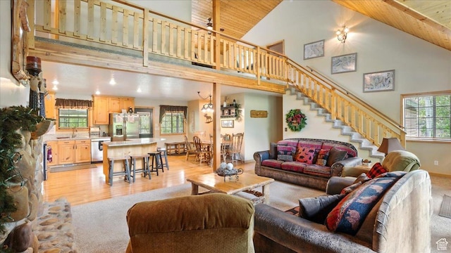 3786 Beaver Creek Rd, Kamas, UT 84036 - living room featuring high vaulted ceiling, light colored carpet, stairway, wood ceiling, and light wood-style floors