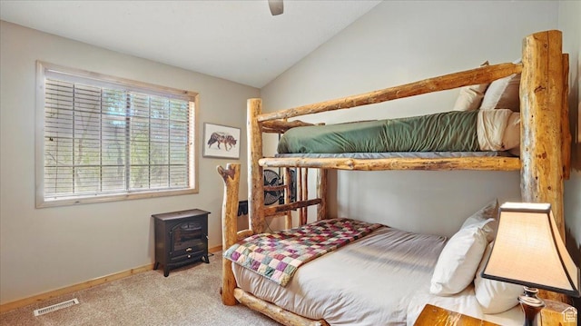 3786 Beaver Creek Rd, Kamas, UT 84036 - bedroom with a wood stove, carpet, lofted ceiling, baseboards, and a ceiling fan