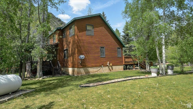 3786 Beaver Creek Rd, Kamas, UT 84036 - view of side of home featuring stairway, a deck, and a lawn