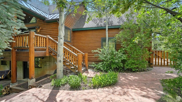 3786 Beaver Creek Rd, Kamas, UT 84036 - view of property exterior featuring log siding, a standing seam roof, a patio, metal roof, and a shingled roof