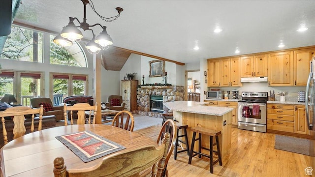 3786 Beaver Creek Rd, Kamas, UT 84036 - dining space with a chandelier, recessed lighting, plenty of natural light, light wood-style floors, and a stone fireplace