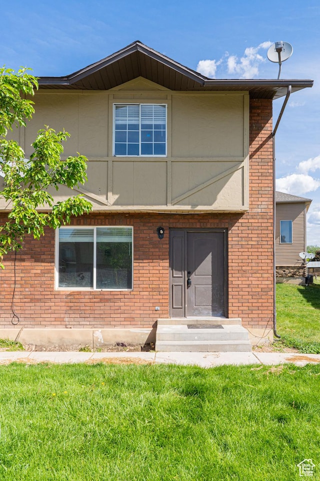 1560 W 300 S # 1, Vernal, UT 84078 - back of house with a lawn, brick siding, and entry steps