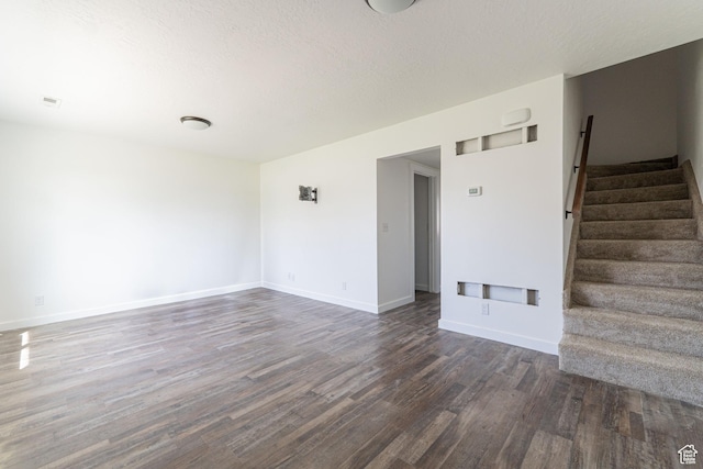1560 W 300 S # 1, Vernal, UT 84078 - spare room featuring dark wood-style floors, stairs, baseboards, and a textured ceiling
