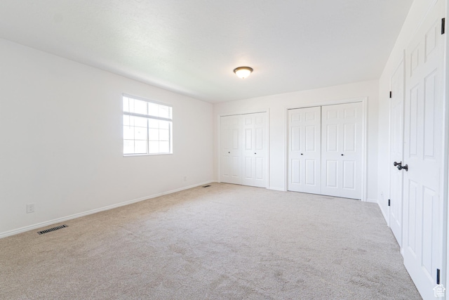 1560 W 300 S # 1, Vernal, UT 84078 - unfurnished bedroom with light carpet, two closets, and baseboards
