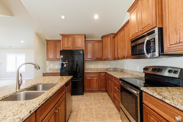 344 E 2280 N Unit C, North Logan, UT 84341 - kitchen with appliances with stainless steel finishes, a sink, brown cabinets, light stone countertops, and recessed lighting