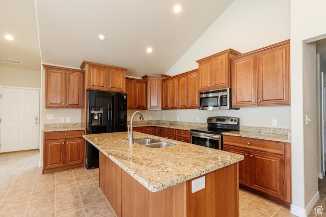 344 E 2280 N Unit C, North Logan, UT 84341 - kitchen featuring stainless steel appliances, a sink, vaulted ceiling, brown cabinets, and a kitchen island with sink