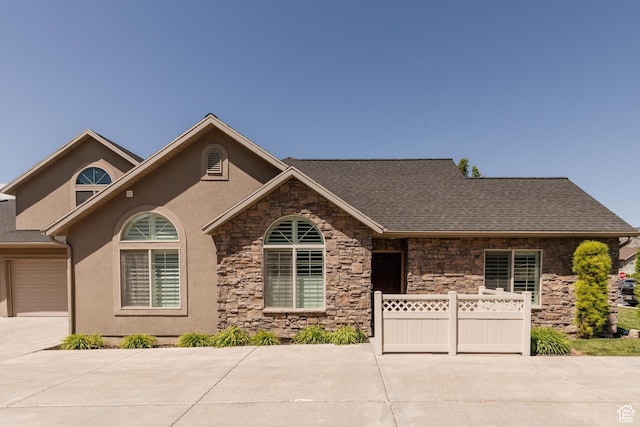 344 E 2280 N Unit C, North Logan, UT 84341 - view of front of home featuring stone siding, driveway, stucco siding, and an attached garage