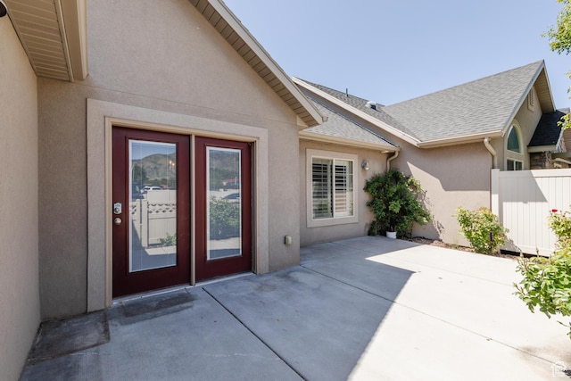 344 E 2280 N Unit C, North Logan, UT 84341 - property entrance with stucco siding, a patio area, and a shingled roof