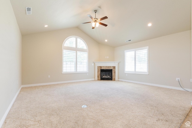 344 E 2280 N Unit C, North Logan, UT 84341 - unfurnished living room featuring a ceiling fan, vaulted ceiling, a fireplace, baseboards, and light colored carpet