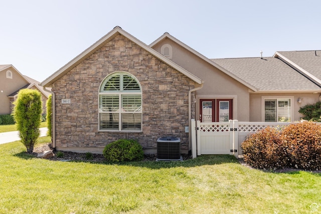 344 E 2280 N Unit C, North Logan, UT 84341 - view of front facade with stone siding, a front lawn, stucco siding, and central AC