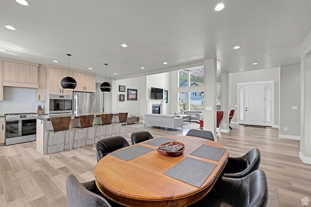 3877 N 425 E, North Ogden, UT 84414 - dining room featuring recessed lighting, light wood-style floors, and baseboards