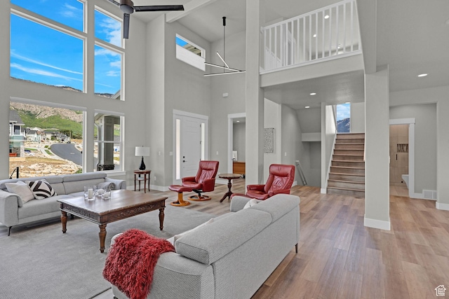 3877 N 425 E, North Ogden, UT 84414 - living area with wood finished floors, stairs, baseboards, a high ceiling, and recessed lighting