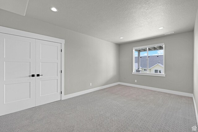 3877 N 425 E, North Ogden, UT 84414 - unfurnished bedroom featuring carpet, a textured ceiling, recessed lighting, baseboards, and a closet