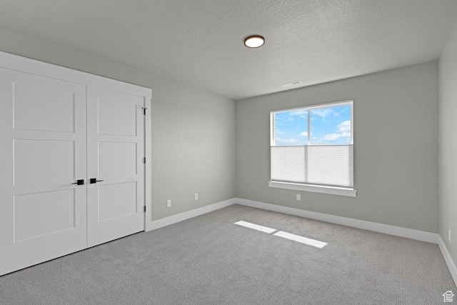 3877 N 425 E, North Ogden, UT 84414 - unfurnished bedroom with carpet, baseboards, a textured ceiling, and a closet