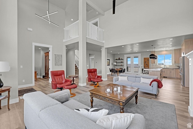 3877 N 425 E, North Ogden, UT 84414 - living room featuring light wood finished floors, stairway, baseboards, a high ceiling, and recessed lighting