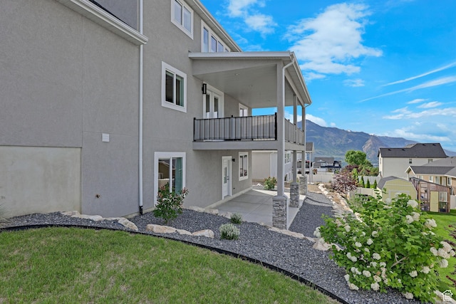3877 N 425 E, North Ogden, UT 84414 - exterior space featuring a balcony, a mountain view, and a patio
