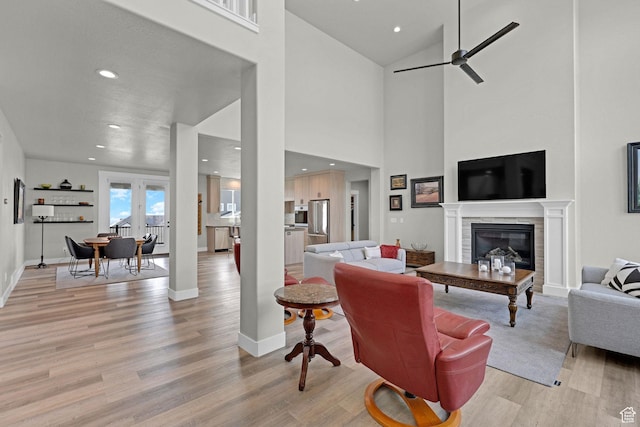 3877 N 425 E, North Ogden, UT 84414 - living area with light wood-style flooring, recessed lighting, ceiling fan, baseboards, and a glass covered fireplace
