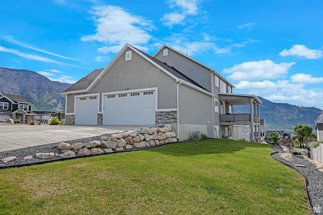 3877 N 425 E, North Ogden, UT 84414 - view of side of home featuring a garage, concrete driveway, a mountain view, a yard, and a balcony