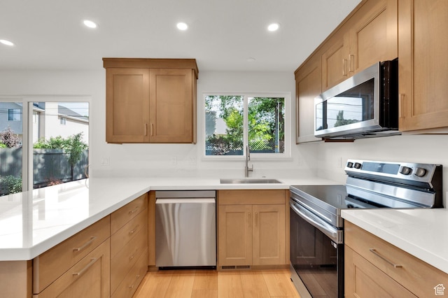 1210 E Bonner Way S, Millcreek, UT 84117 - kitchen with appliances with stainless steel finishes, a sink, recessed lighting, light countertops, and a peninsula