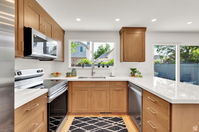 1210 E Bonner Way S, Millcreek, UT 84117 - kitchen with appliances with stainless steel finishes, a sink, a peninsula, plenty of natural light, and recessed lighting