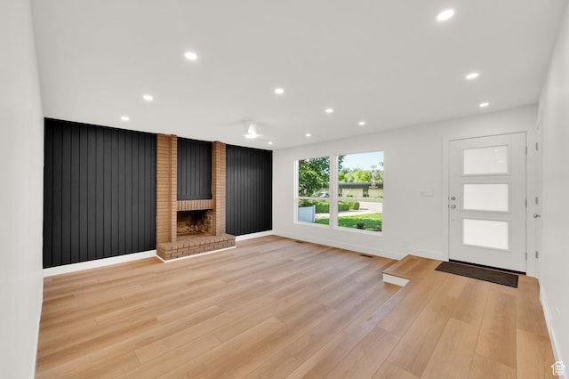 1210 E Bonner Way S, Millcreek, UT 84117 - unfurnished living room featuring recessed lighting, a brick fireplace, light wood-style floors, and baseboards