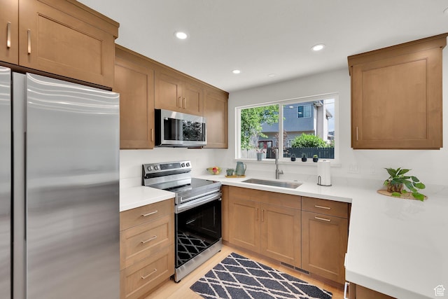 1210 E Bonner Way S, Millcreek, UT 84117 - kitchen with appliances with stainless steel finishes, a sink, recessed lighting, light countertops, and light wood-style floors