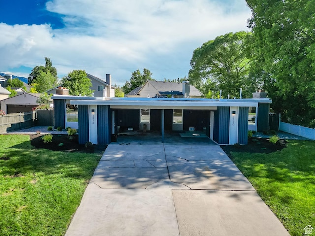 1210 E Bonner Way S, Millcreek, UT 84117 - view of front of house featuring driveway, board and batten siding, a chimney, and a carport