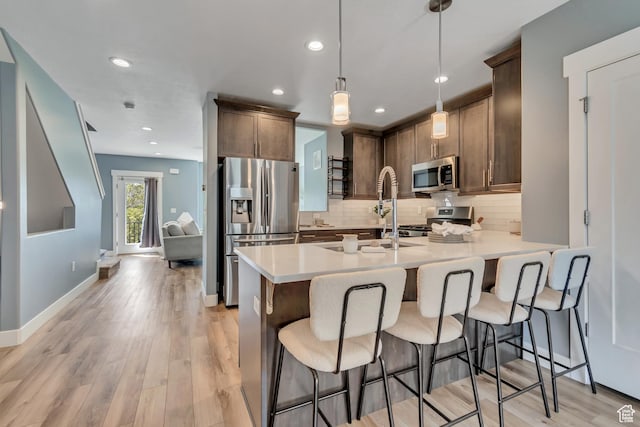 4237 S Birkhill Blvd, Murray, UT 84107 - kitchen with stainless steel appliances, tasteful backsplash, a peninsula, a breakfast bar, and recessed lighting