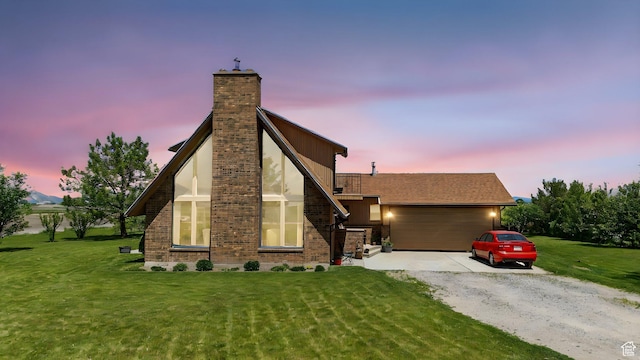 1777 W 4200 N, Smithfield, UT 84335 - view of front of house with gravel driveway, a chimney, a front lawn, an attached garage, and brick siding
