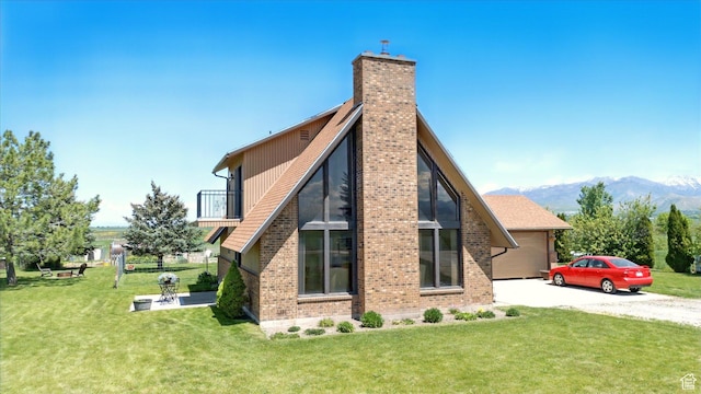 1777 W 4200 N, Smithfield, UT 84335 - view of home's exterior featuring driveway, a chimney, a lawn, a balcony, and a mountain view
