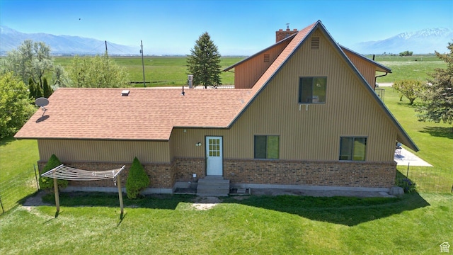 1777 W 4200 N, Smithfield, UT 84335 - view of front of home featuring brick siding, a chimney, a front lawn, and a mountain view