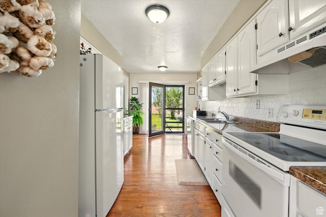 1777 W 4200 N, Smithfield, UT 84335 - kitchen featuring white appliances, under cabinet range hood, a sink, dark countertops, and white cabinetry