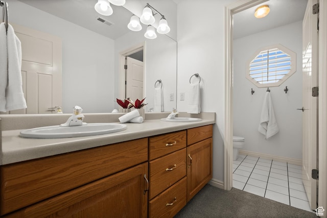 12563 S Bear Castle Cv, Draper, UT 84020 - bathroom featuring double vanity, toilet, tile patterned floors, and baseboards