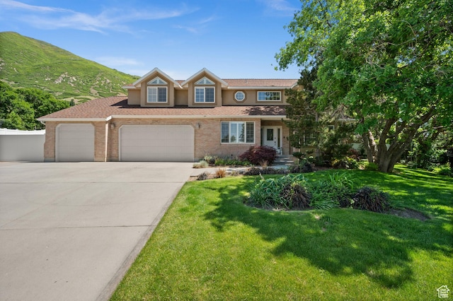 12563 S Bear Castle Cv, Draper, UT 84020 - view of front of house with concrete driveway, a garage, a front yard, and brick siding