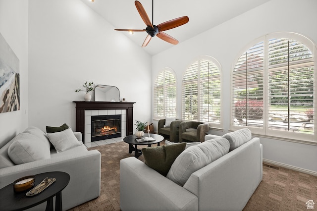 12563 S Bear Castle Cv, Draper, UT 84020 - carpeted living room featuring a ceiling fan, a tile fireplace, and high vaulted ceiling