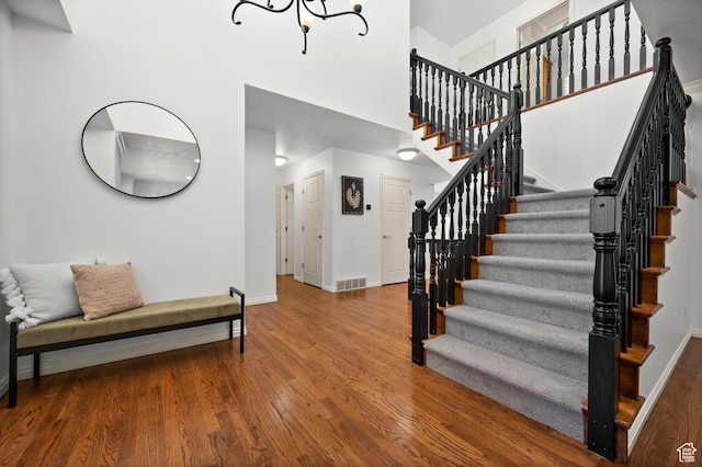 12563 S Bear Castle Cv, Draper, UT 84020 - stairs featuring baseboards, a high ceiling, wood finished floors, and a chandelier