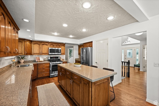 12563 S Bear Castle Cv, Draper, UT 84020 - kitchen with appliances with stainless steel finishes, a sink, recessed lighting, a center island, and dark wood finished floors