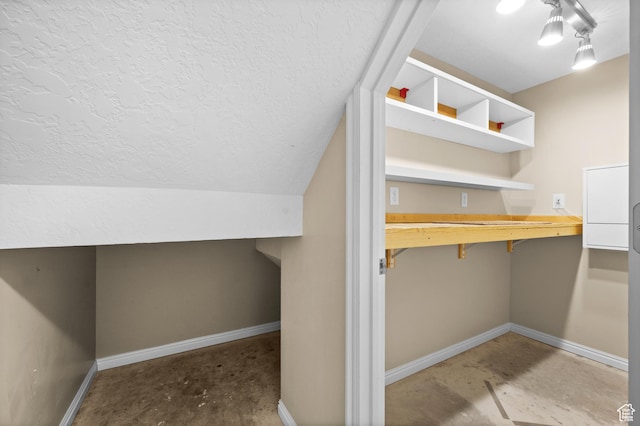 12563 S Bear Castle Cv, Draper, UT 84020 - bonus room with unfinished concrete floors, baseboards, a textured ceiling, and a desk