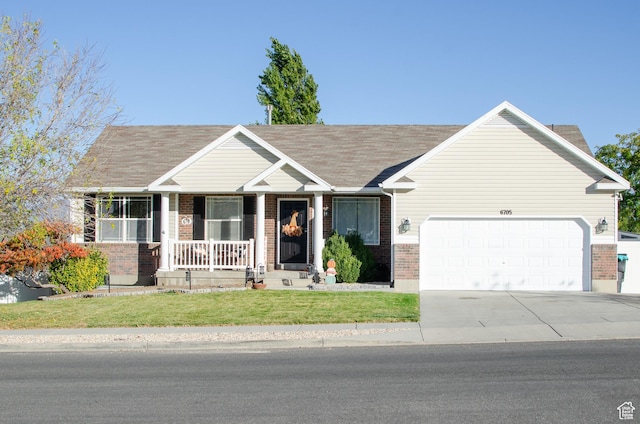 6705 S High Bluff Dr W, West Jordan, UT 84081 - view of front of property with brick siding, covered porch, a garage, a front yard, and driveway