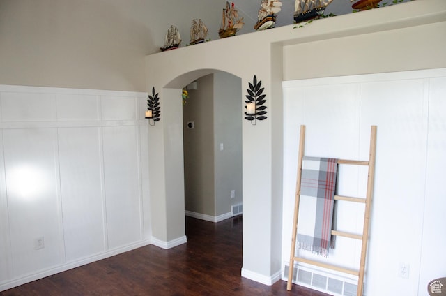 6705 S High Bluff Dr W, West Jordan, UT 84081 - spare room featuring arched walkways and dark wood-type flooring