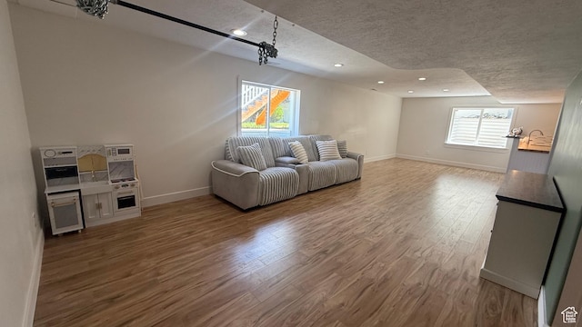 6705 S High Bluff Dr W, West Jordan, UT 84081 - living room with a textured ceiling, wood finished floors, and recessed lighting