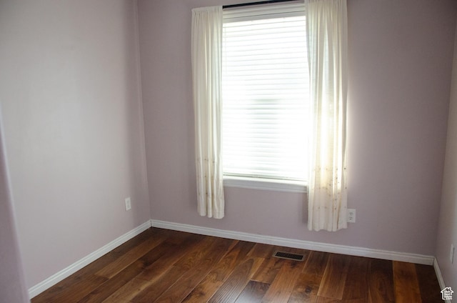 6705 S High Bluff Dr W, West Jordan, UT 84081 - unfurnished room featuring baseboards, dark wood-type flooring, and healthy amount of natural light