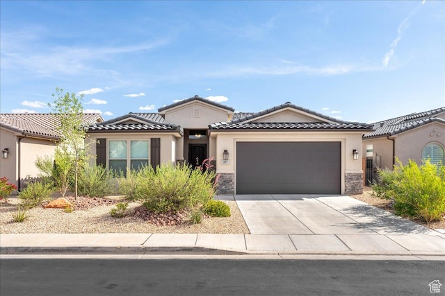 227 W White Pearl Dr, Washington, UT 84780 - mediterranean / spanish-style home featuring stucco siding, stone siding, a garage, and driveway